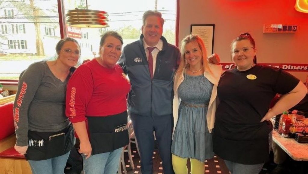 NH Governor Chris Sununu visits Red Arrow Diner in Concord and poses with Red Arrow Diner employees.
